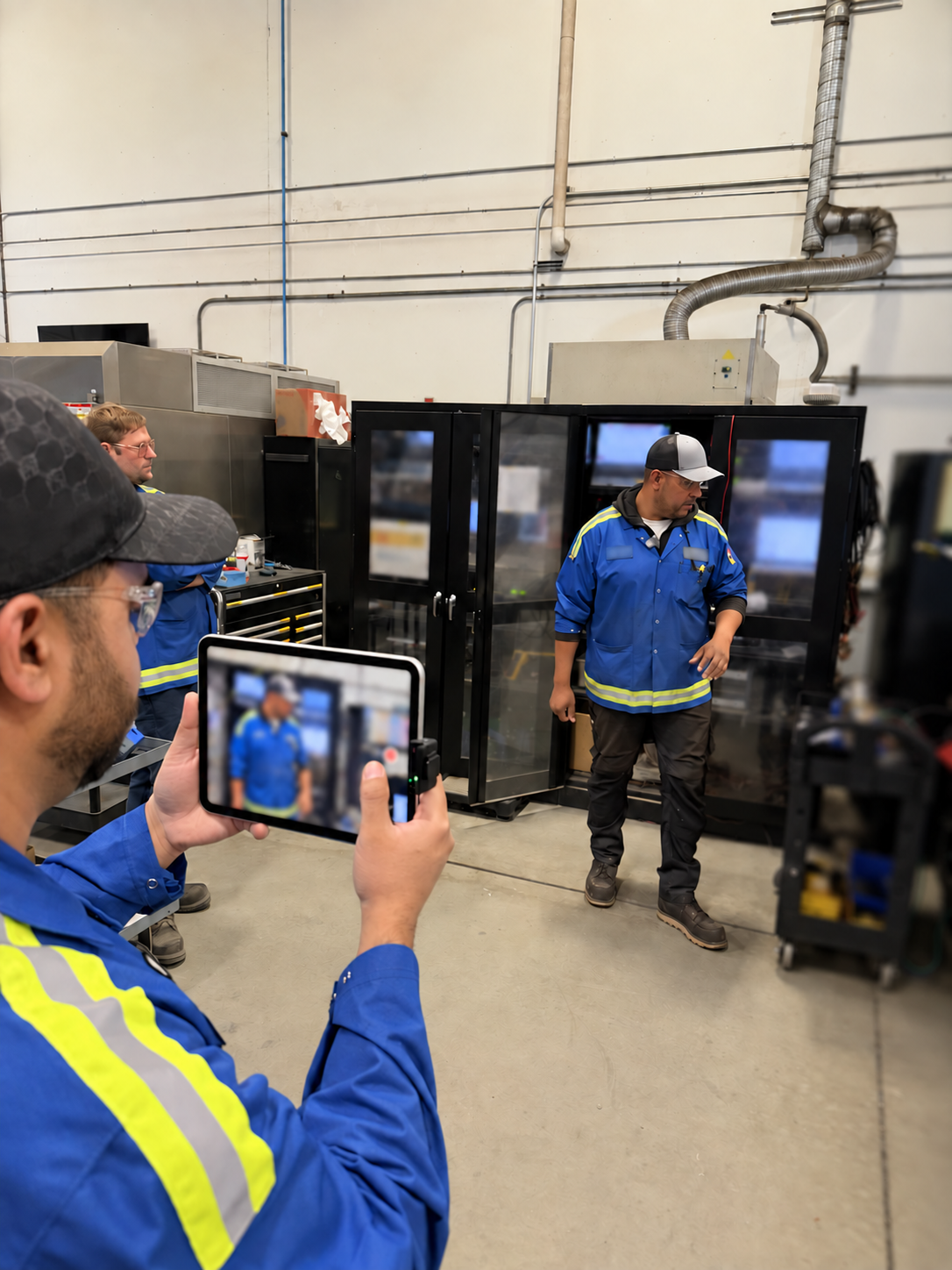 Team recording a shop-floor demonstration on a tablet